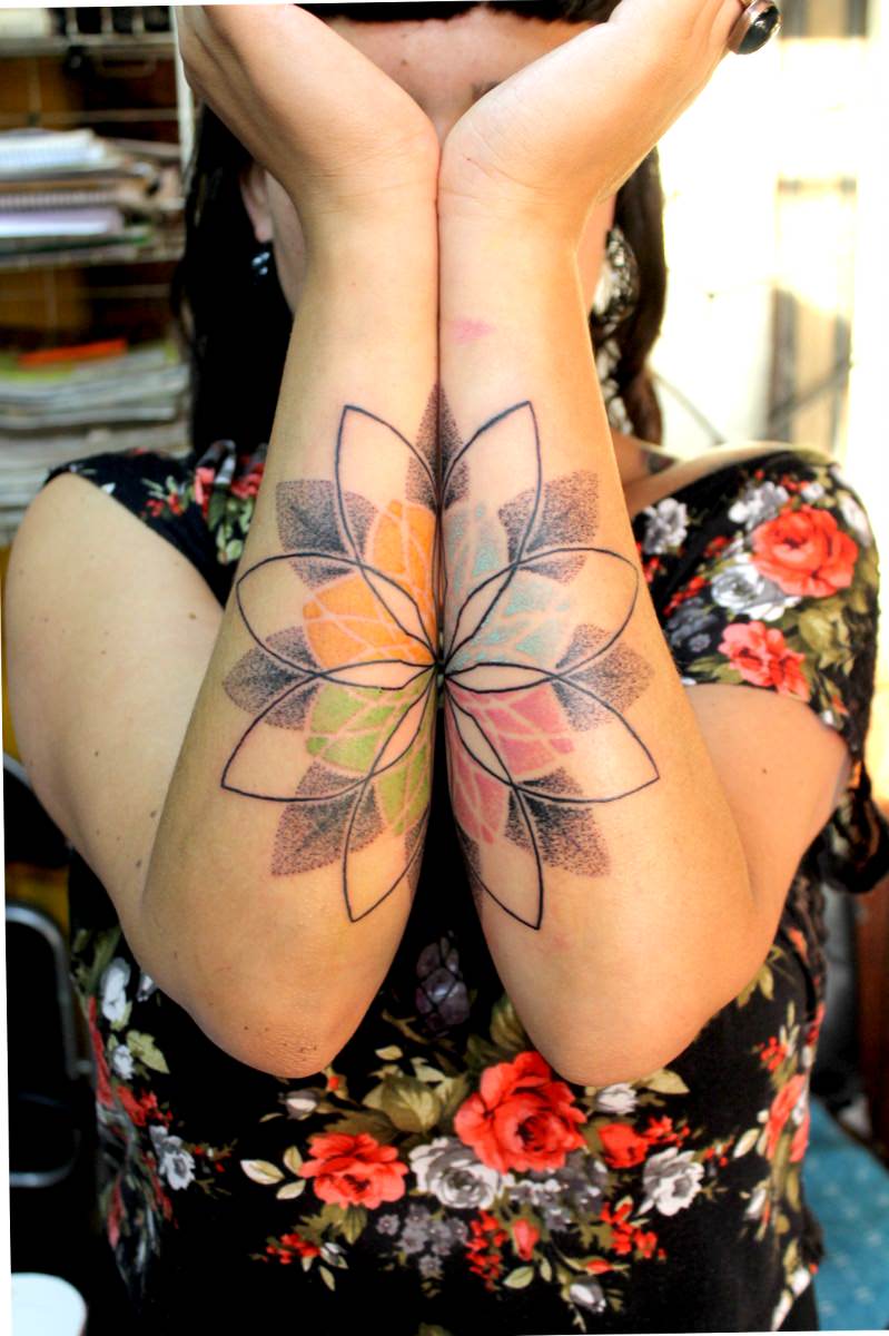 colored mandala tattoo on arms