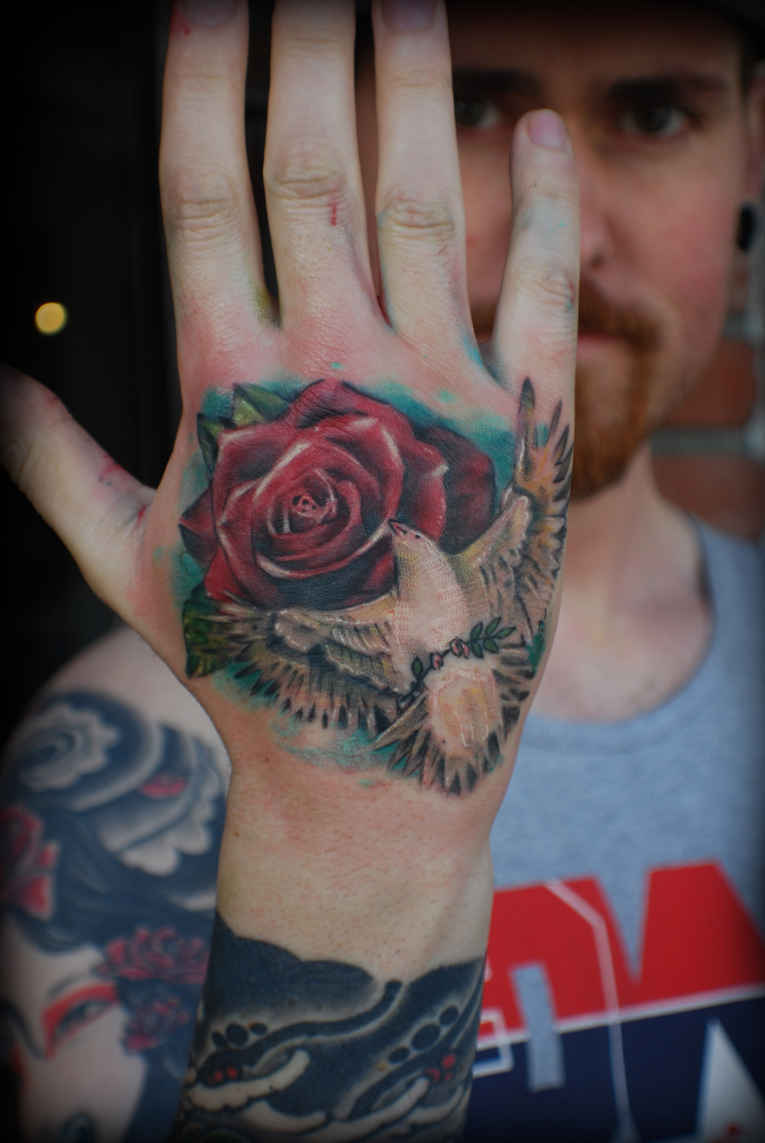 dove and rose tattoon on wrist 