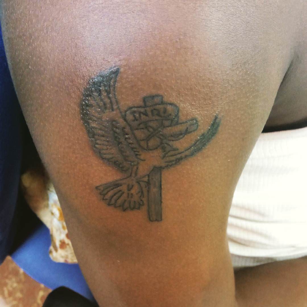 dove with cross tattoo on sleeve