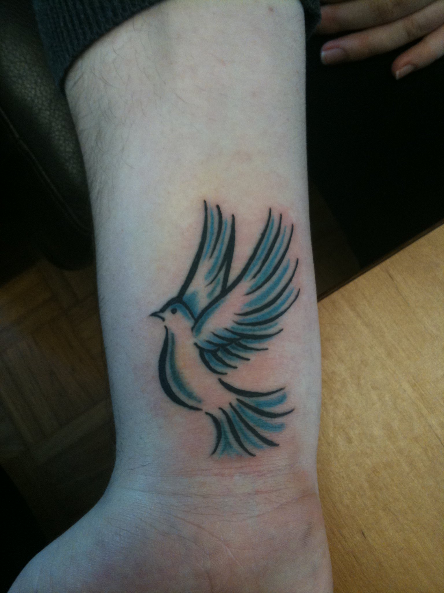 flying dove tattoo on wrist