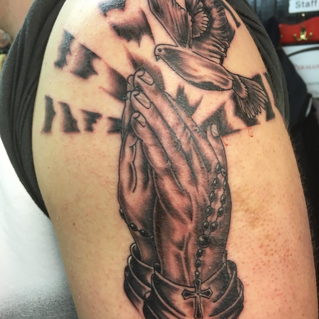 praying hands with dove tattoo on sleeve