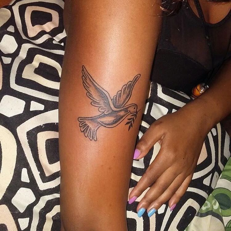 small dove tattoo on arm