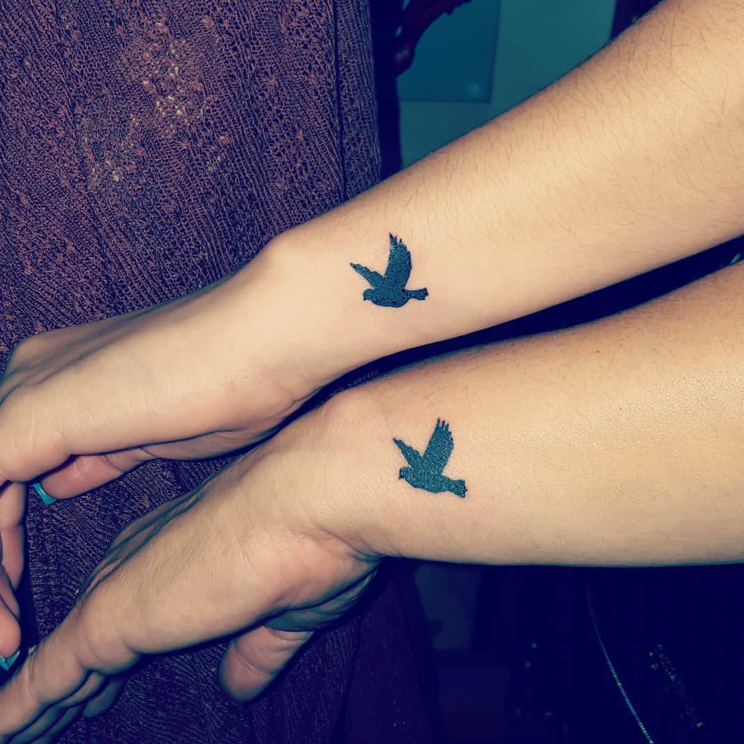 small dove tattoo on wrist
