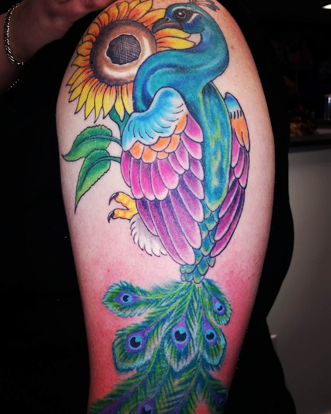 blue peacock tattoo on sleeve