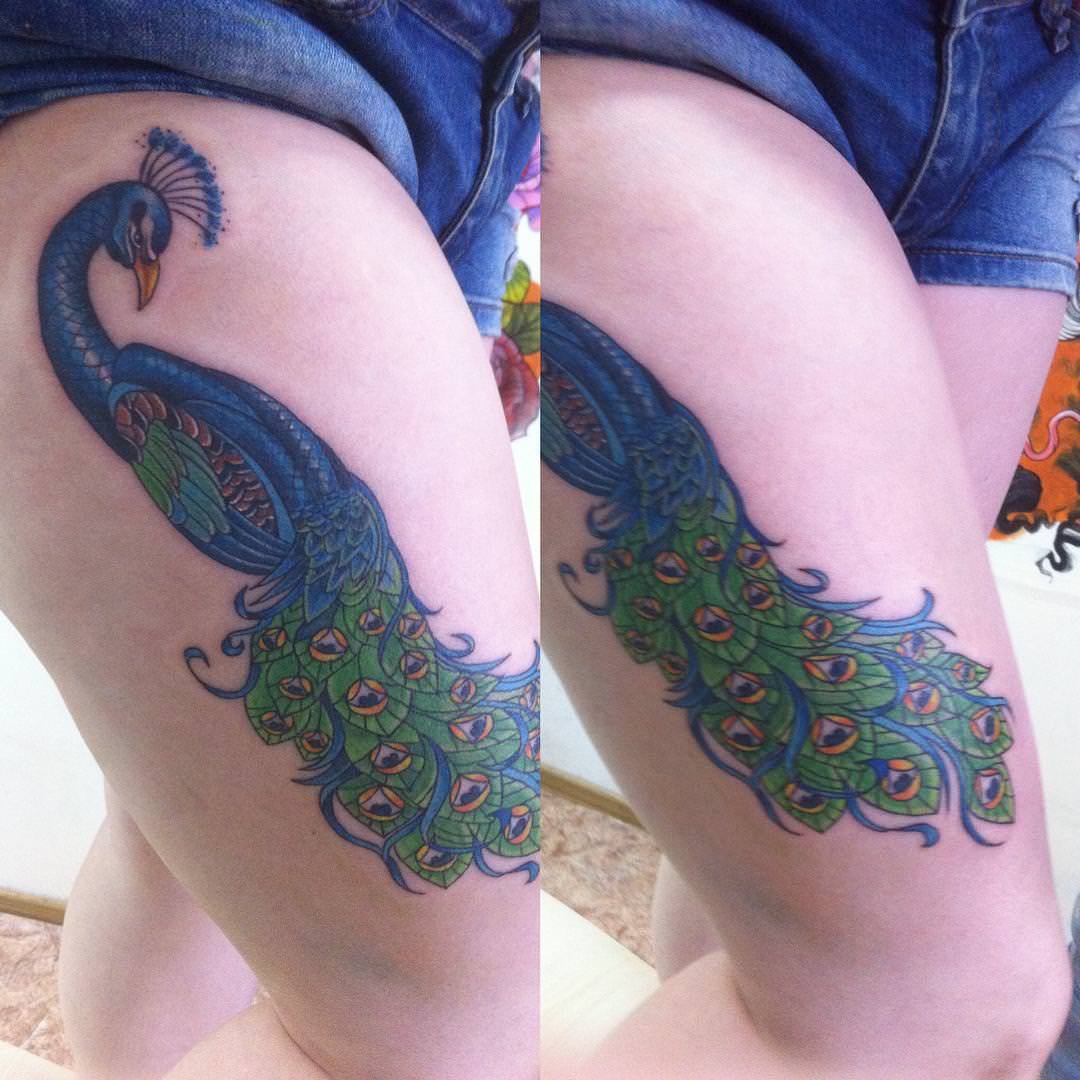 blue tattoo design on thigh