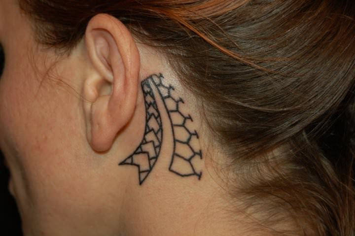 cute polynesian tattoo behind the ear