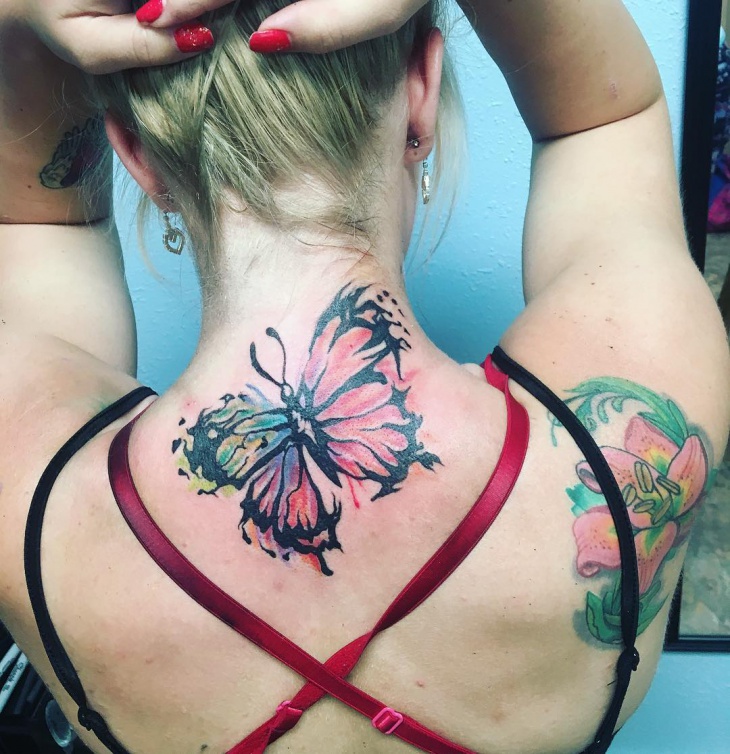 butterfly tattoo on bellow neck