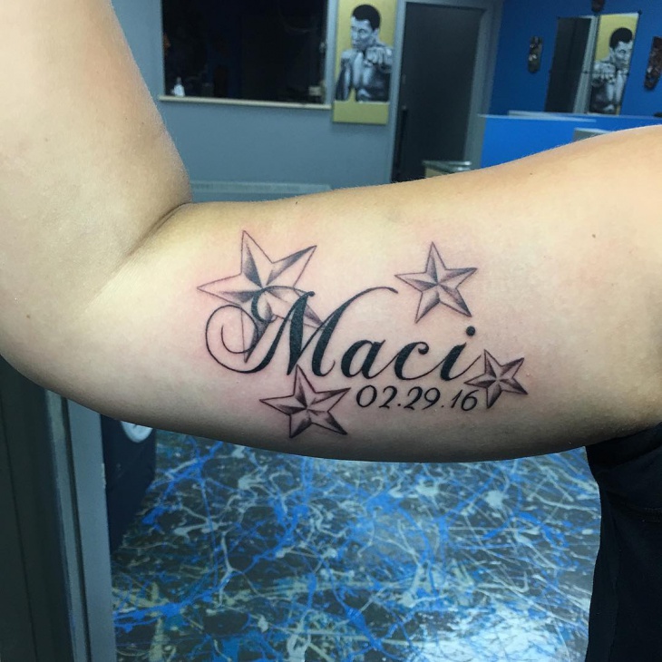 lettering star tattoo on arm
