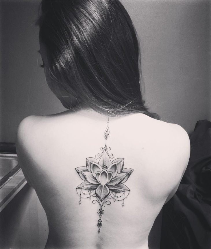 lotus flower spine tattoo design