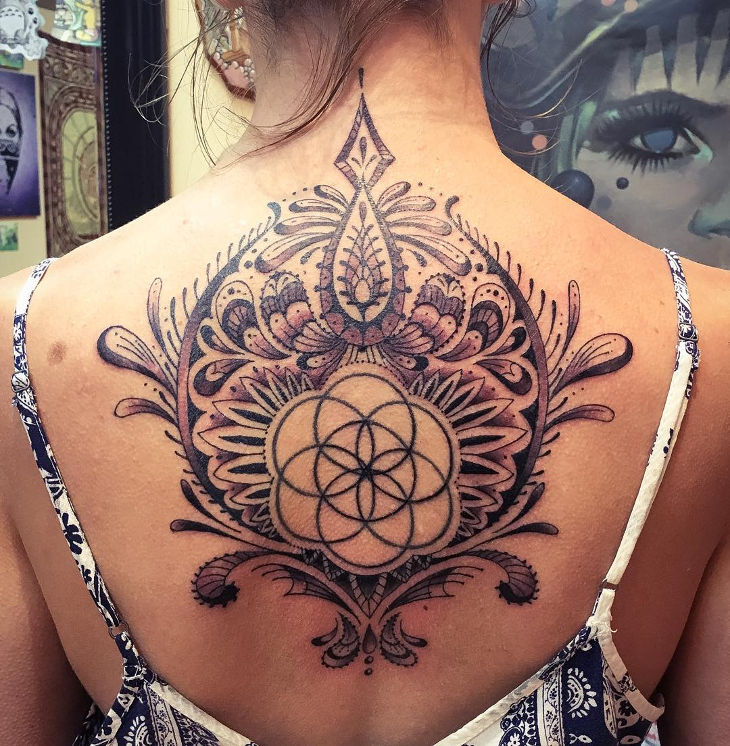 polynesian flower spine tattoo