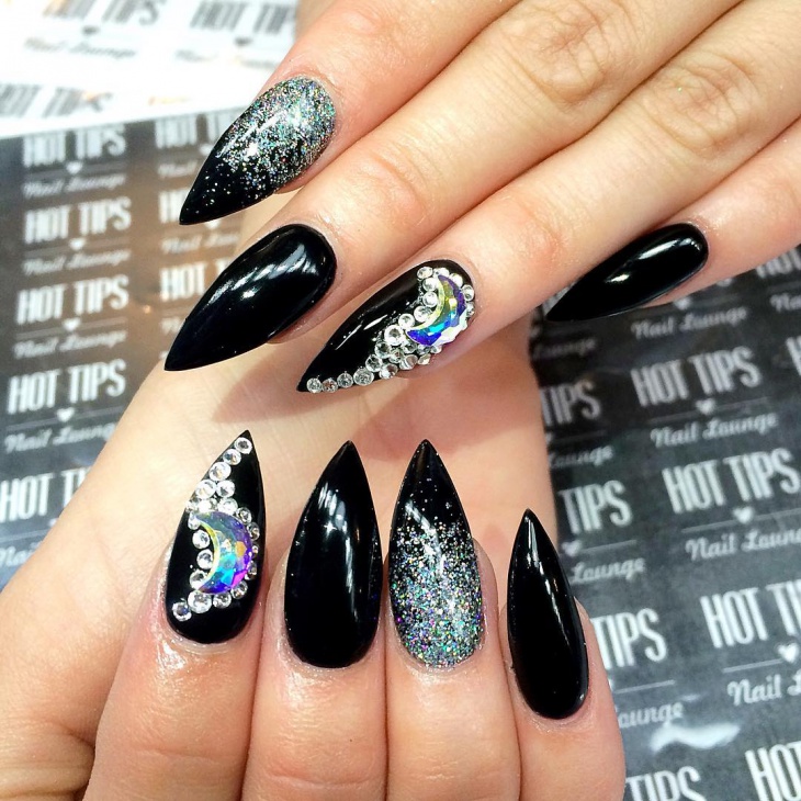 black and glitter nail art on claw nails