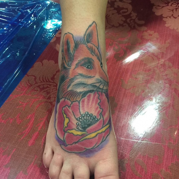 rose with fox tattoo on foot