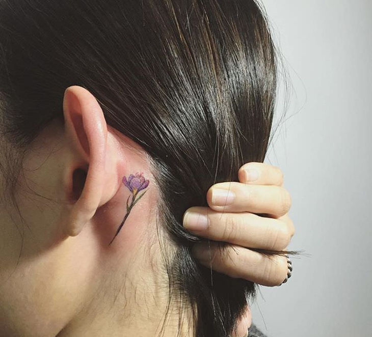 simple flower tattoo on back ear