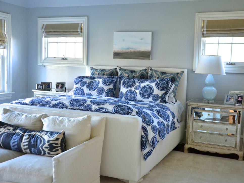 transitional bedroom boasts blue patterned bedding