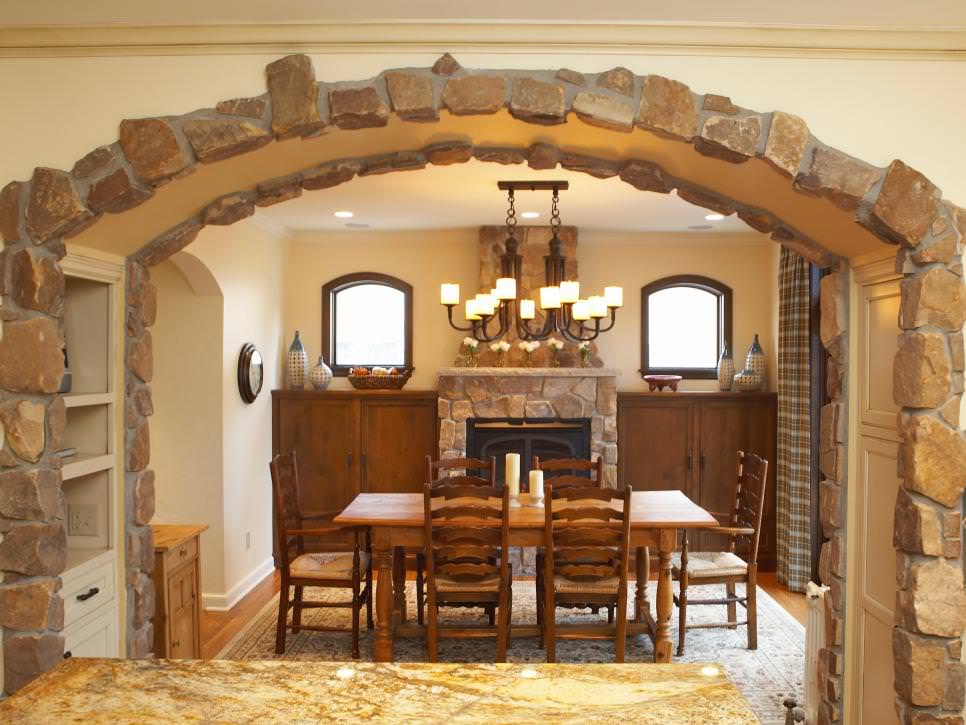 french country dining room with stone arch