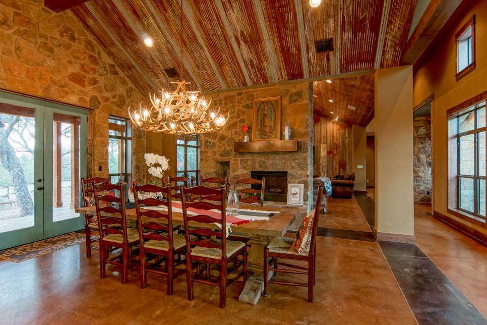 rustic dining room with intricate antler chandelier