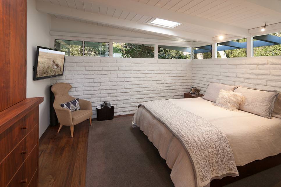 modern bedroom with white painted brick walls