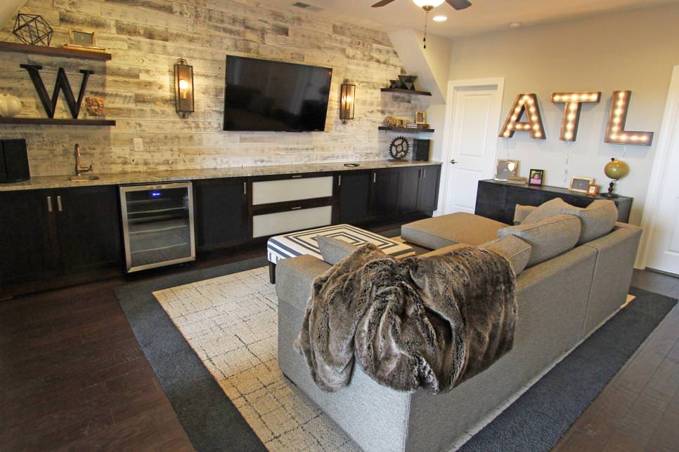 rustic media room with whitewashed wood feature wall