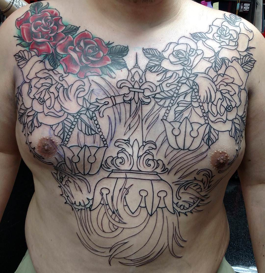 scales tattoo on chest