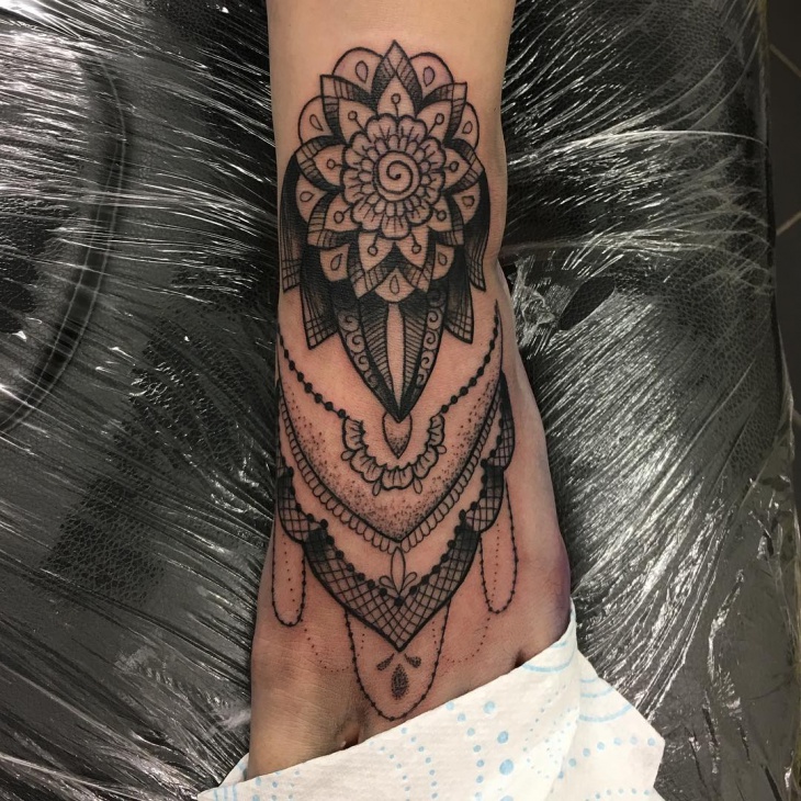 lace tattoo design on foot