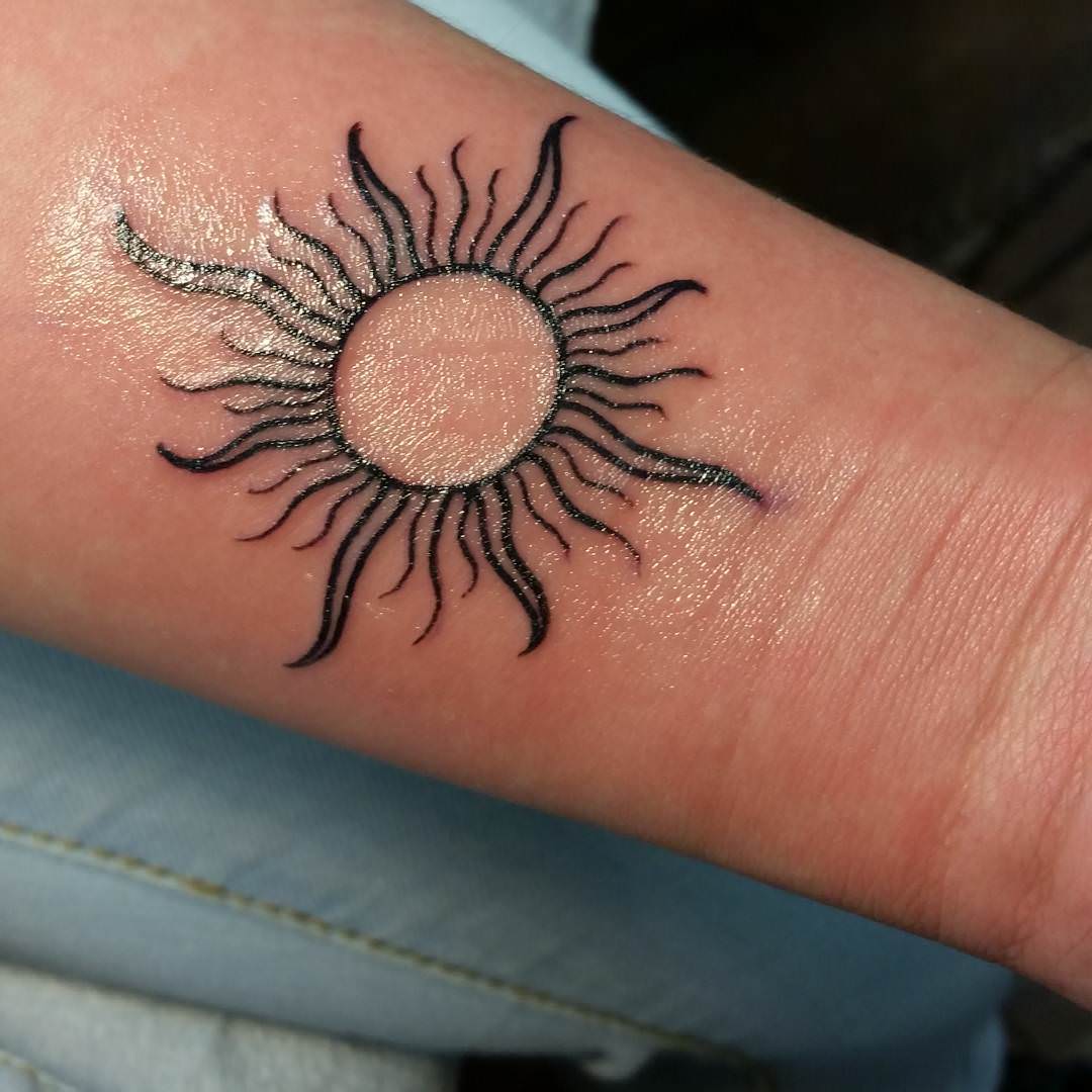 sun tattoo design on wrist