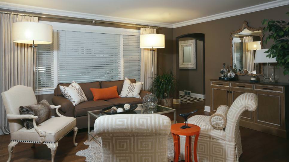 orange accents brighten brown living room
