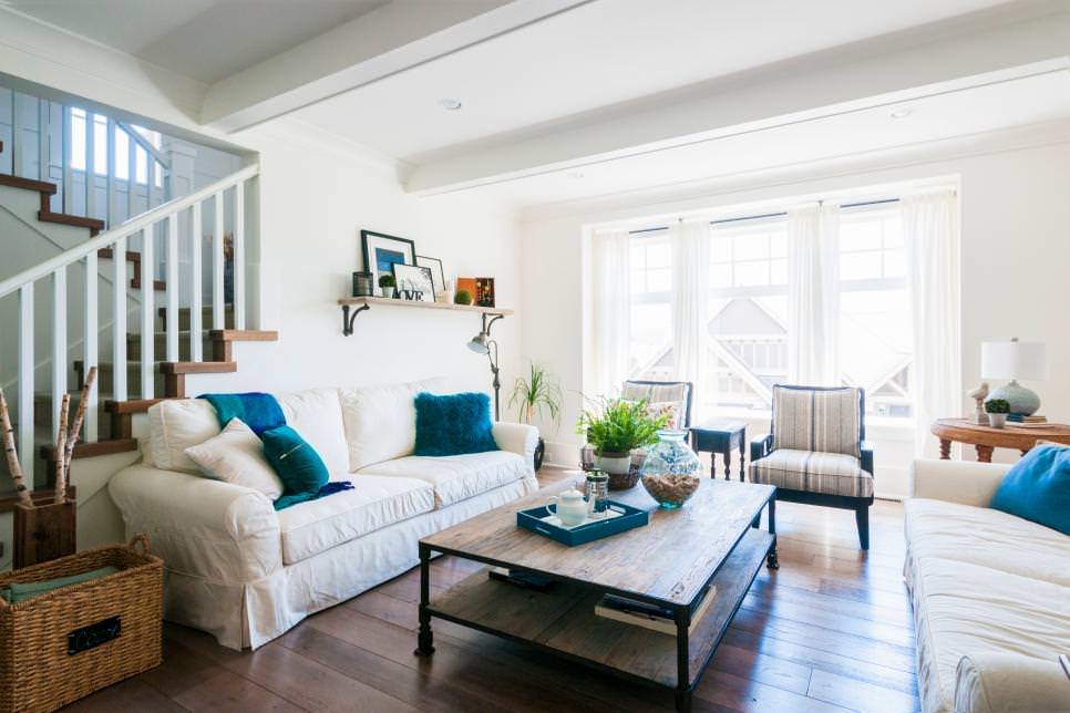 teal pillows pop in white living room