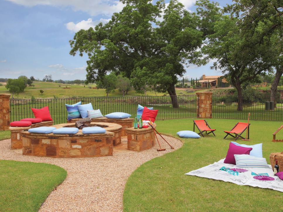 rustic outdoor fire pit with stone benches cushion seating