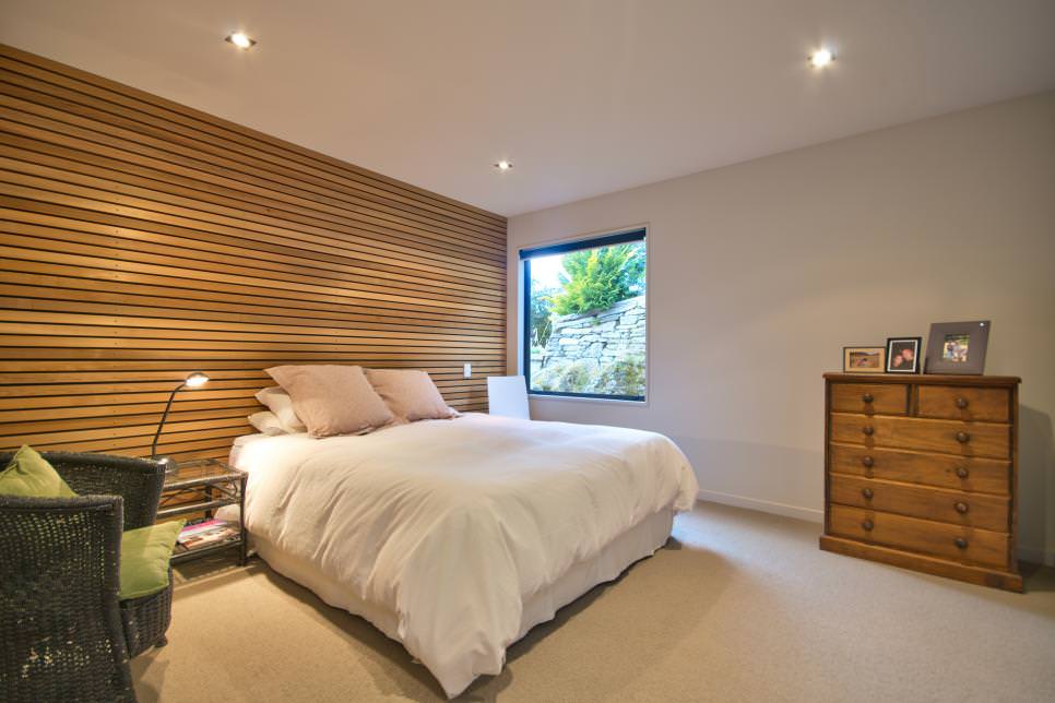 bedroom with wooden accent wall design