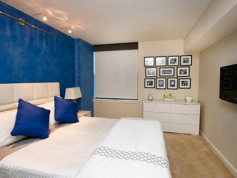 white bedroom with cobalt blue accent wall