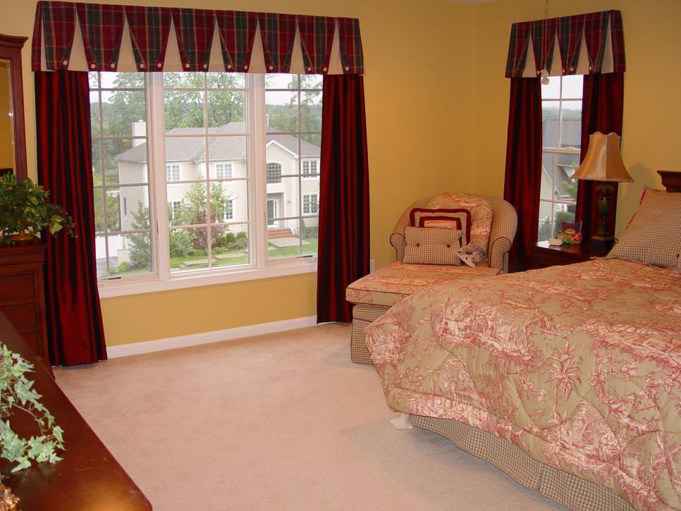 yellow bedroom with red window treatments