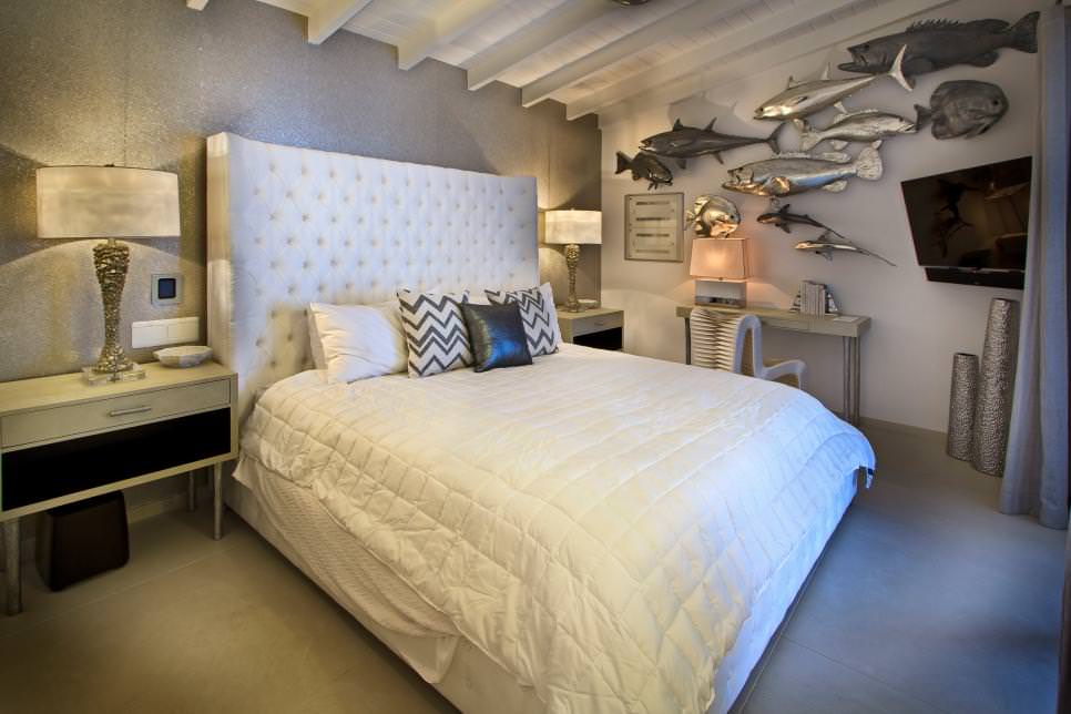 bedroom with metallic fish wall decor