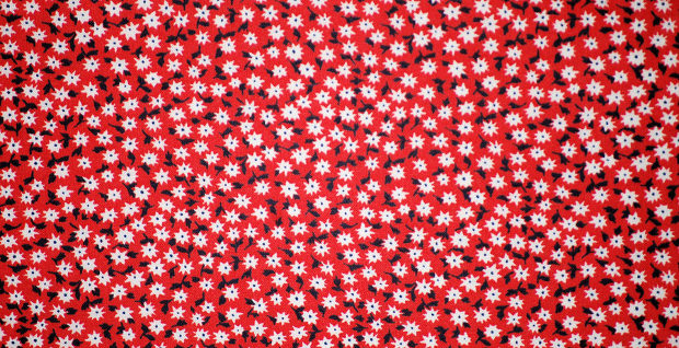 white floral pattern on red fabric