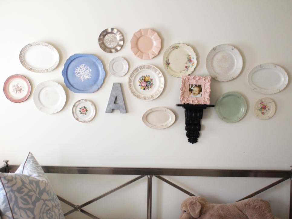 white bedroom wall displays colorful plate decorations
