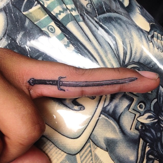 small sword tattoo on finger