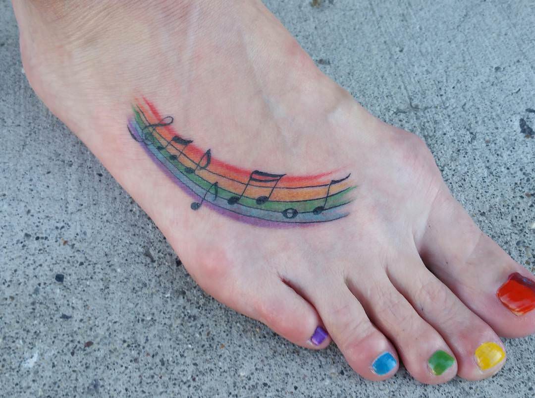colorful music note tattoo on foot