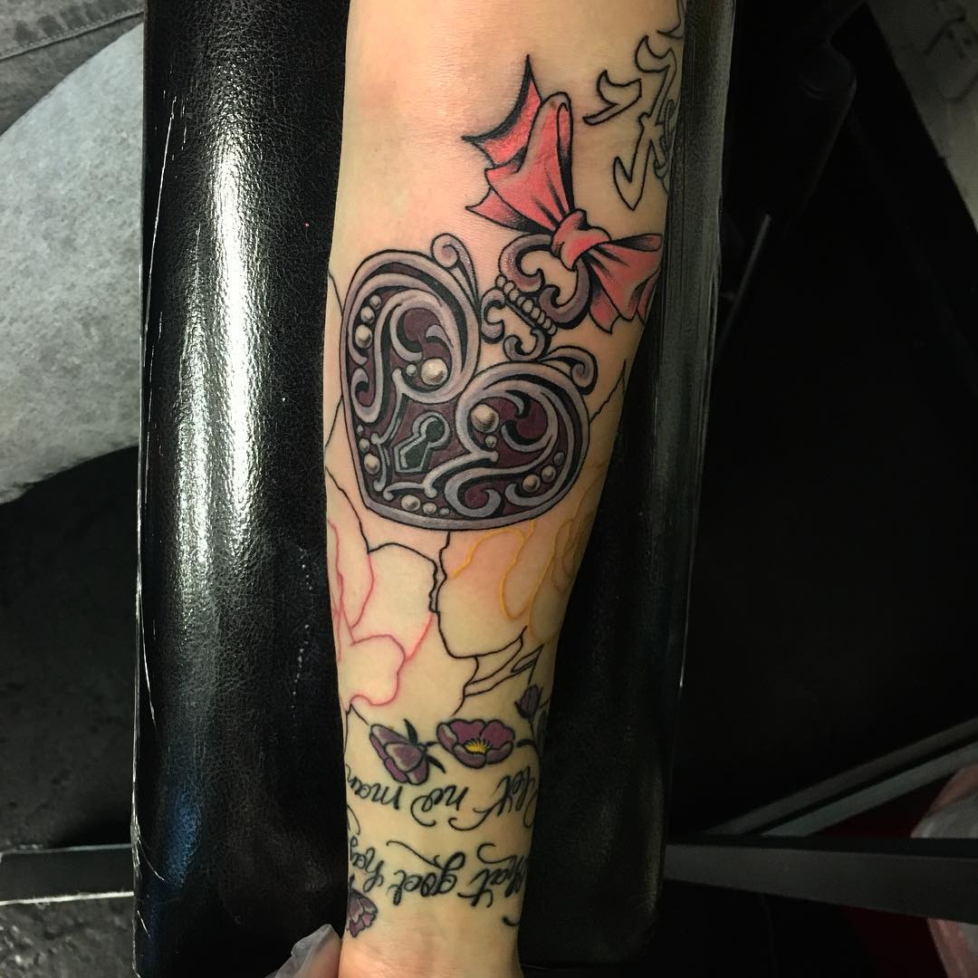 flowers and heart locket tattoo