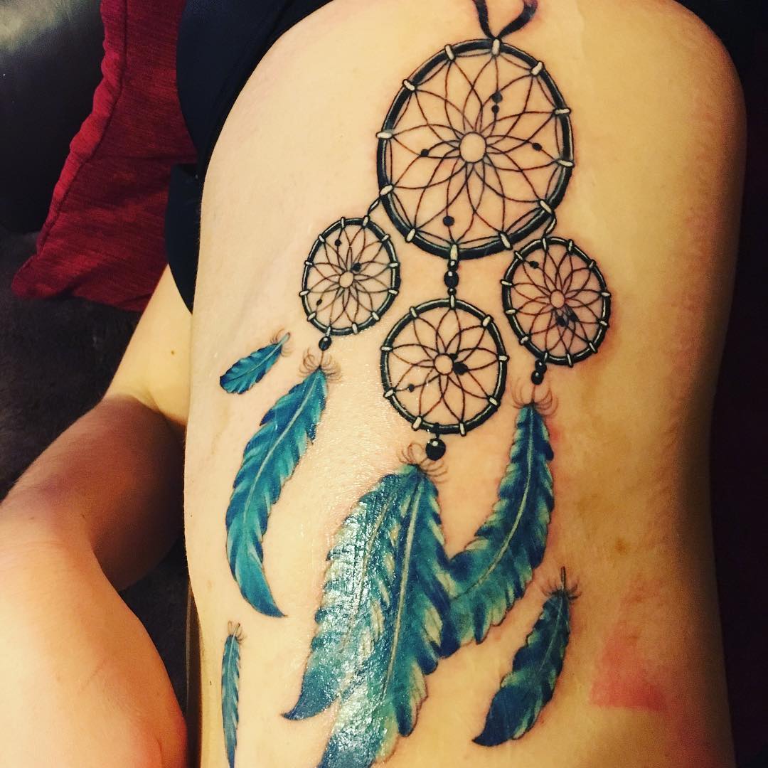 stenncil dream catcher tattoo with feather on ribs