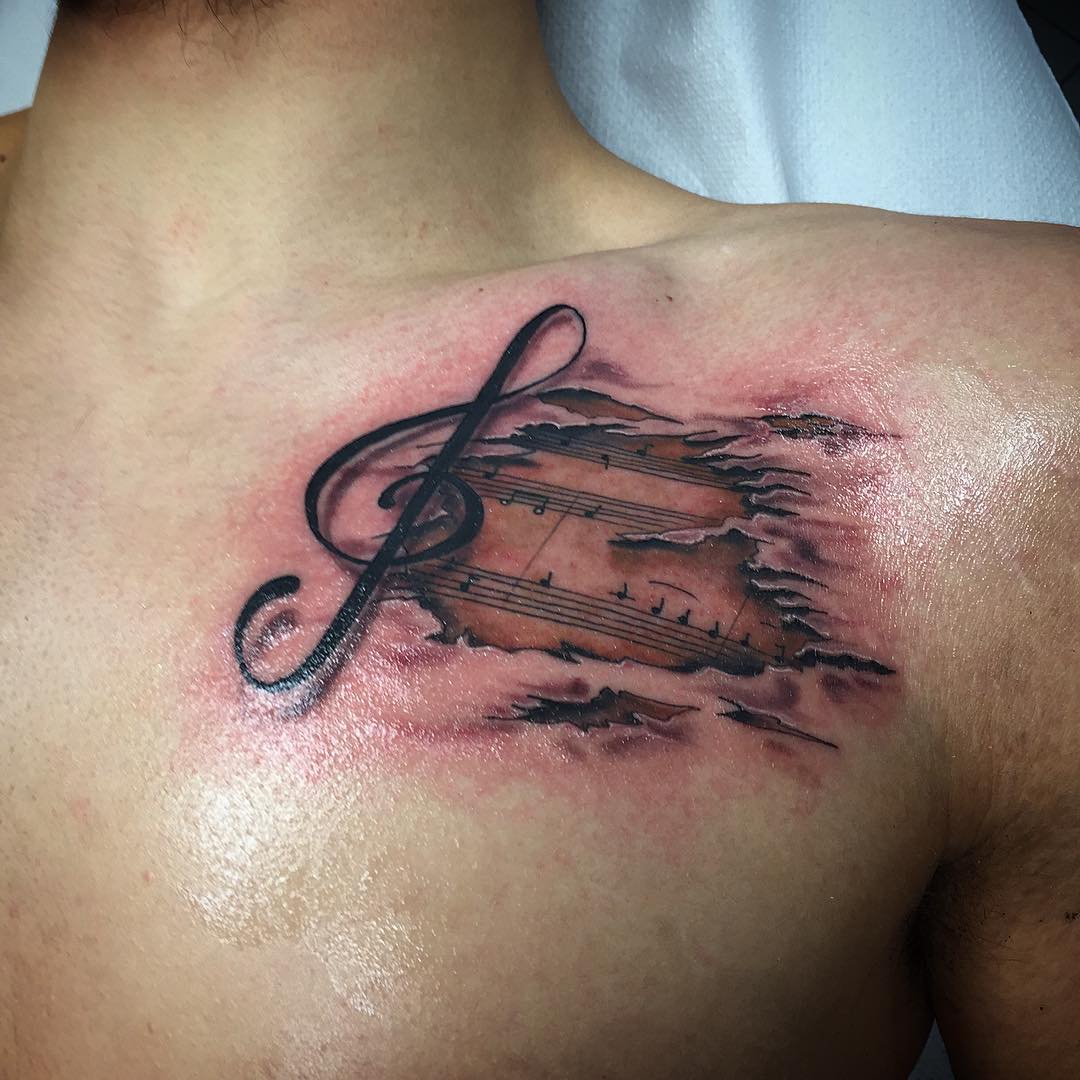 chest music tattoo for men