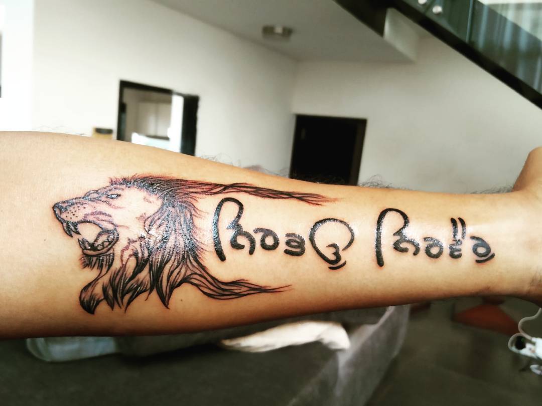 roaring lion with letterings tattoo
