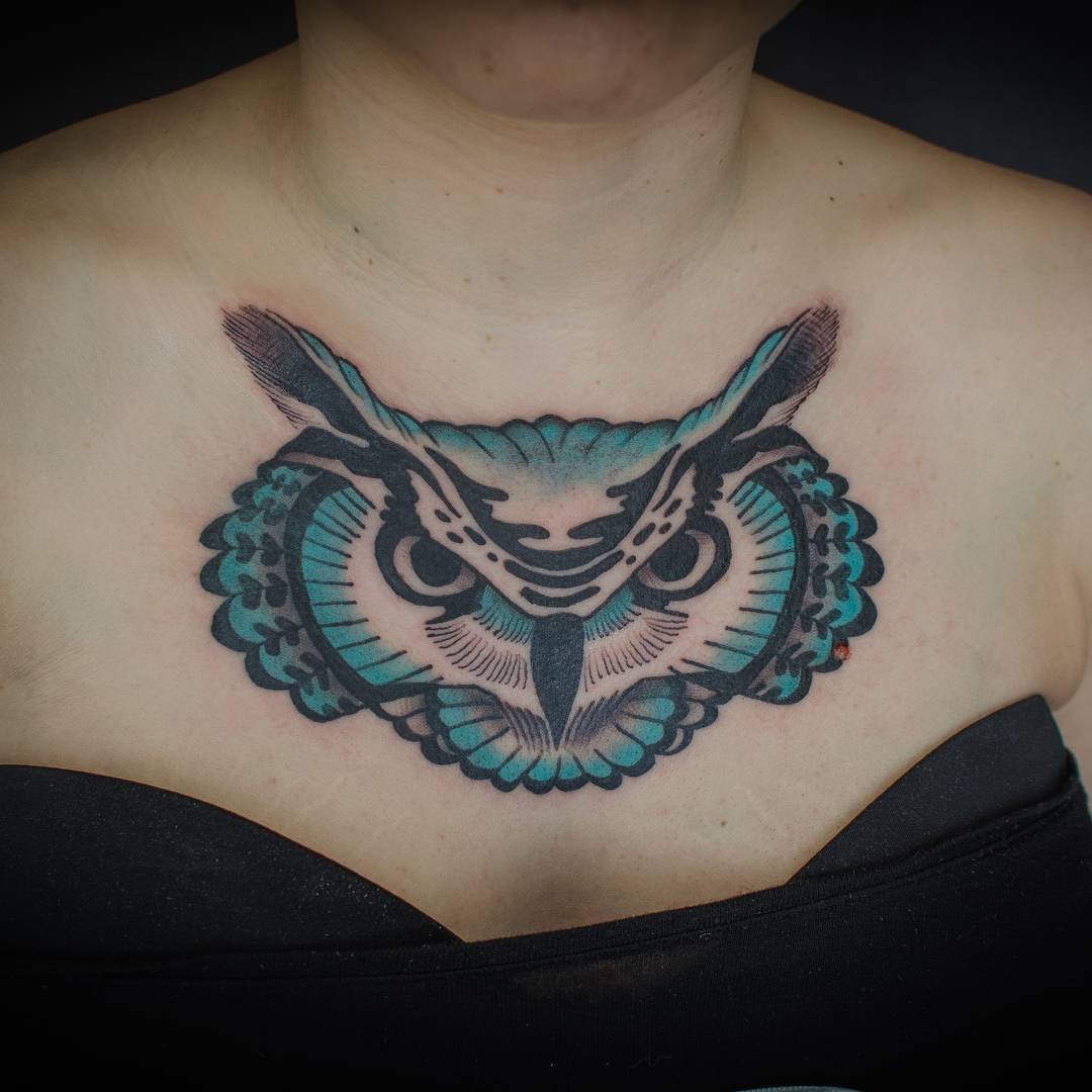 black and blue colored owl tattoo for women