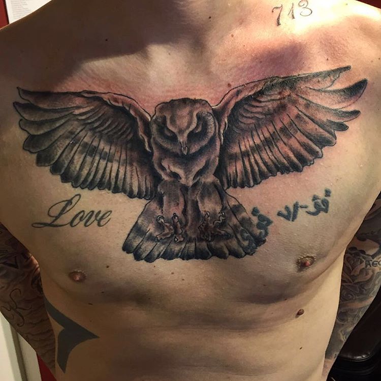 black and grey quirkly owl chest tattoo