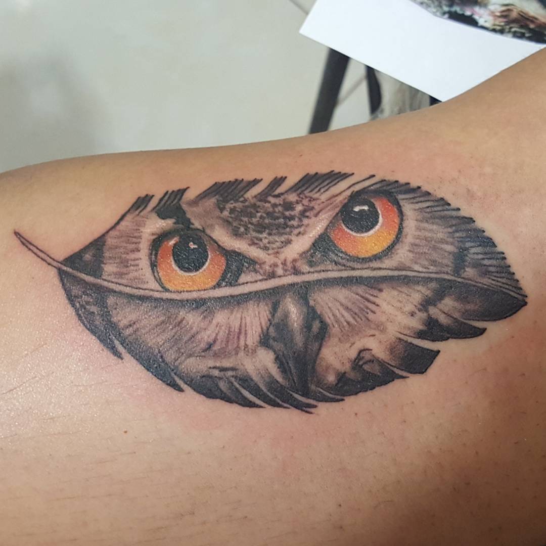owl in a feather tattoo design