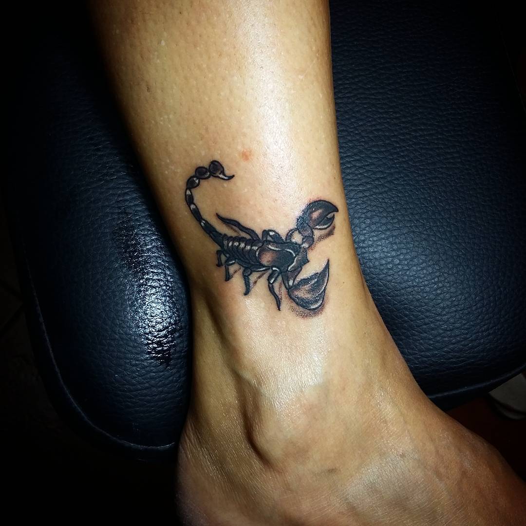little scorpion symbol tattoo on leg