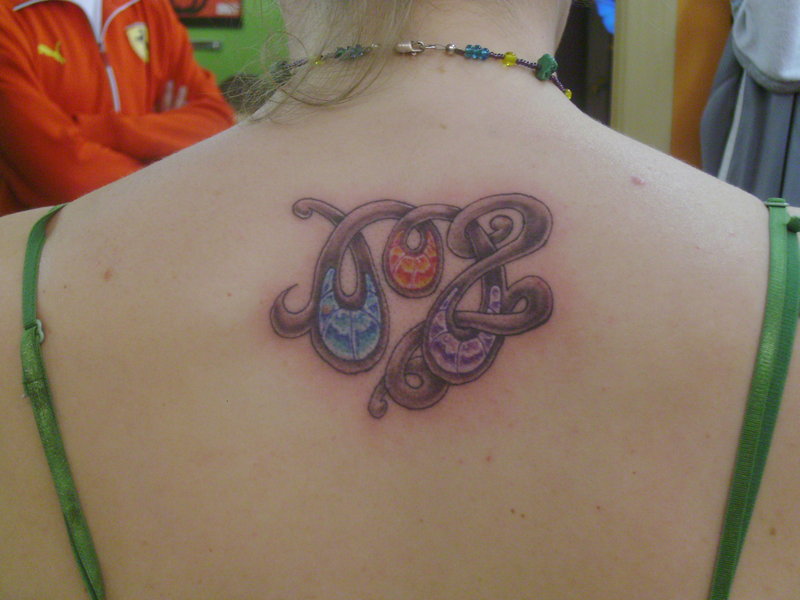 swirling tattoo of virgo for women