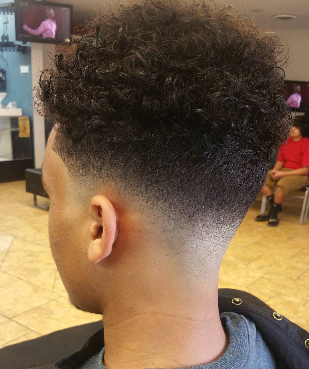 low skin fade with curly hairs