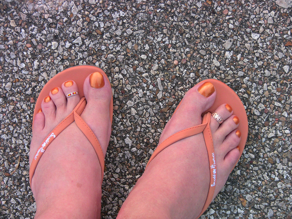 orange colored small toe nail design