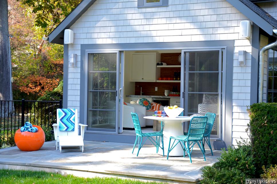 blue chairs and an orange side table in the outdoor space