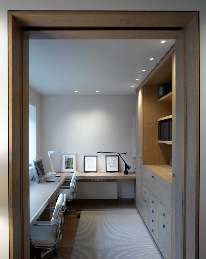 modern office with light hardwood floors