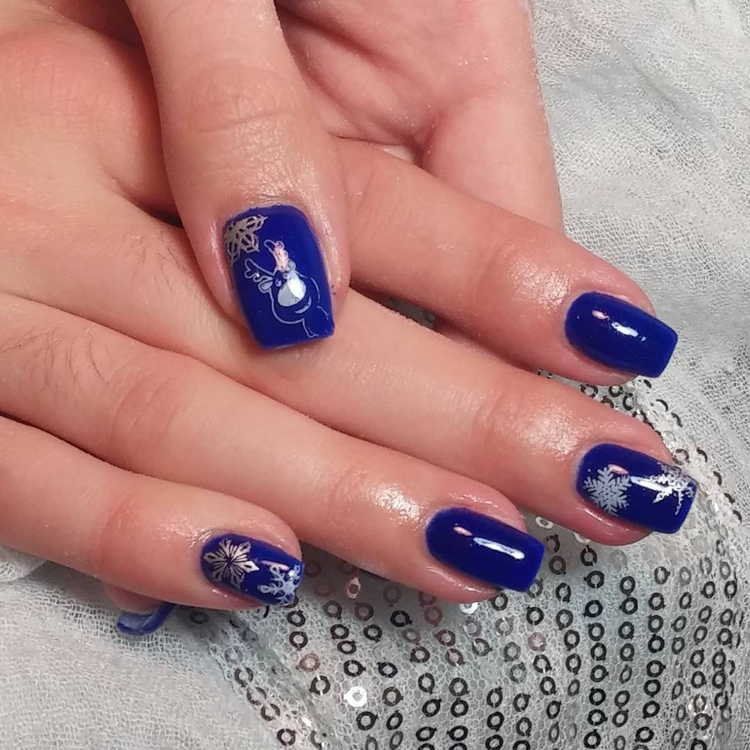 abstract nail design featuring royal blue circles on a white background